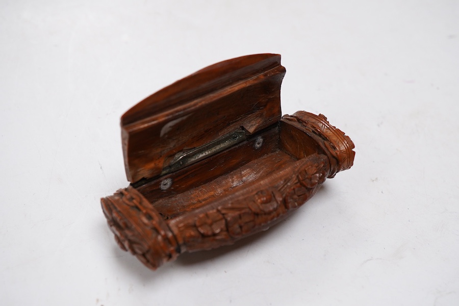 An 18th / 19th century European carved figural coquilla nut snuff box, 8.5cm wide